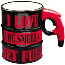Black mug with red lettering red handle in the shape of a gas pump and body of mug in the shape of a fuel drum.