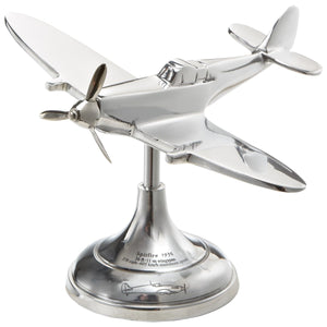 A silver desk model of a Spitfire airplane with a circular base and a vertical stand.