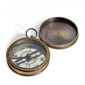 A brass compass with a silver plated dial, etched with compass points, housed in a round case that opens to reveal the compass face.