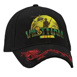 A black cap with a Vietnam Veteran design, featuring a red dragon, a Huey helicopter, and an American soldier embroidered on the front.