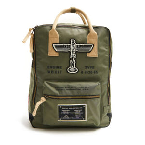 A green Boeing Vintage Logo backpack with branding patch, side pockets, and a front pocket, featuring a tan shoulder strap.