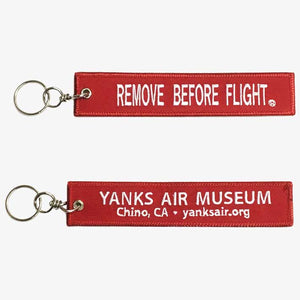 Keychain One says 'REMOVE BEFORE FLIGHT' and the other displays the Yanks Air Museum information.