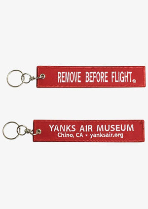 Keychain One says 'REMOVE BEFORE FLIGHT' and the other displays the Yanks Air Museum information.